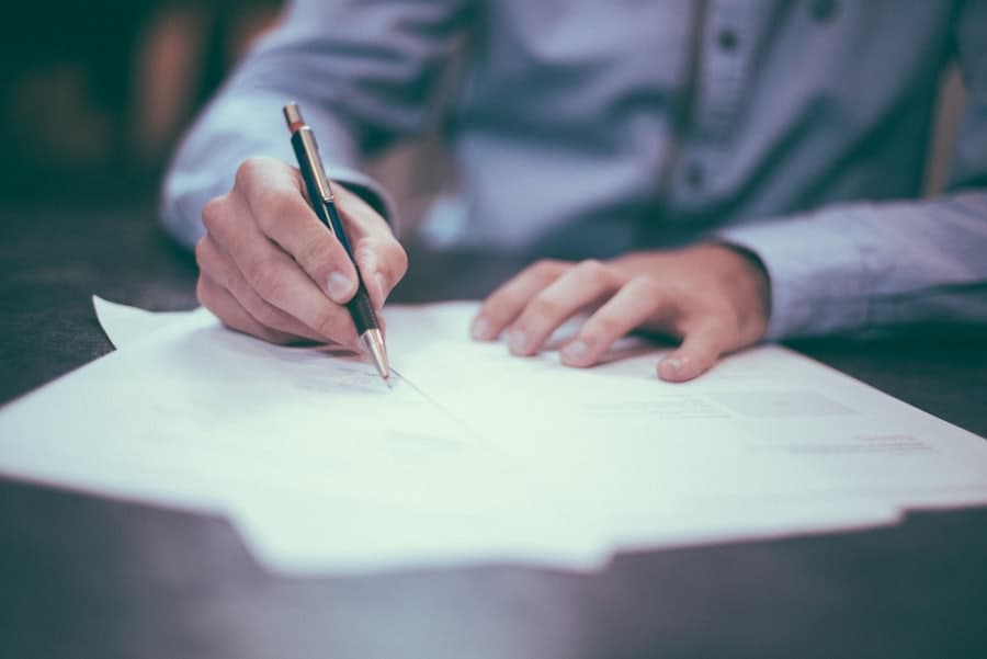 Business professionals reviewing and signing loan documents
